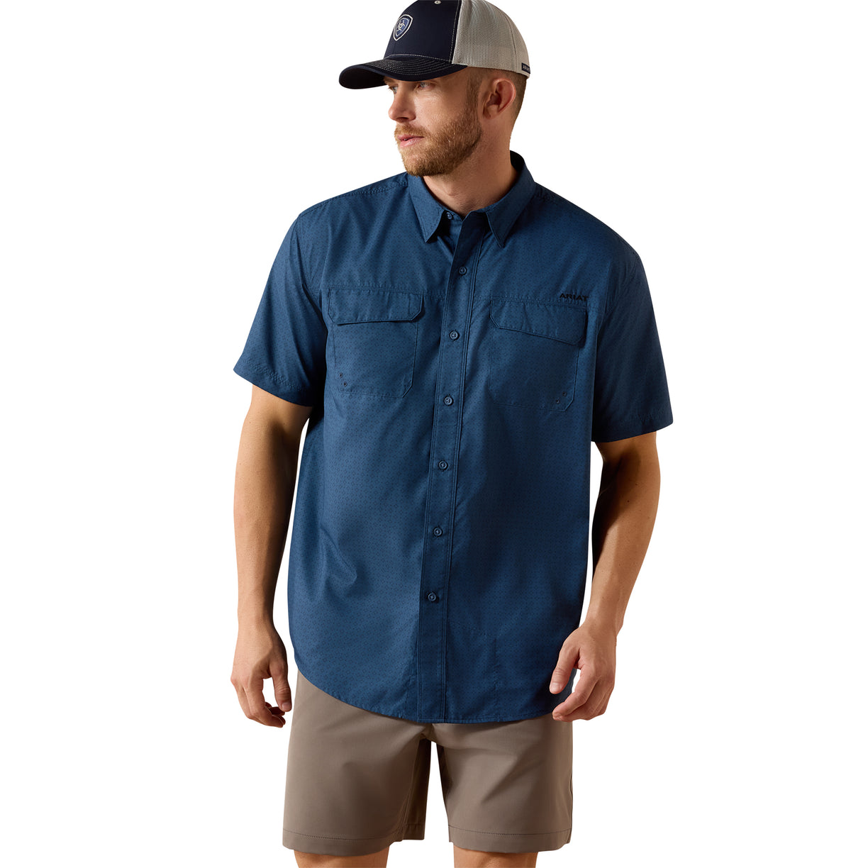 Navy VentTEK Outbound Classic Fit Shirt with a subtle micro-print, short-sleeve with two chest pockets, worn with a cap and khaki shorts.