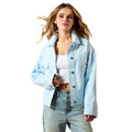Woman wearing a light blue denim jacket and jeans on a white background