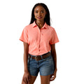 The VentTEK Shirt in coral pink, short-sleeve with a single chest pocket, worn with denim shorts and a brown belt.