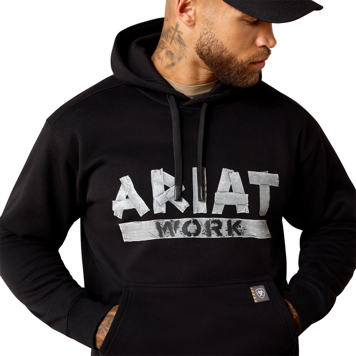 Man wearing a black hoodie with 'Ariat Work' logo on a white background