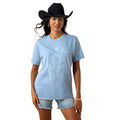 Woman wearing a light blue t-shirt with a design and denim shorts on a white background