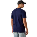 Man wearing a navy blue t-shirt and black cap on a white background