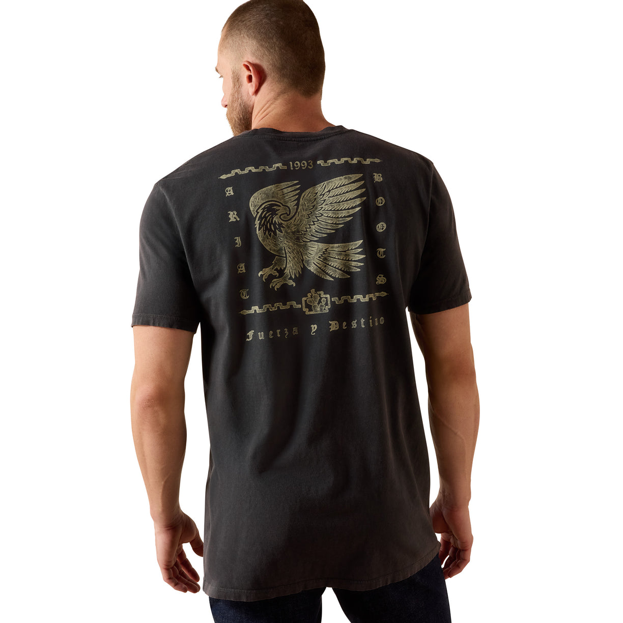 Man wearing a black t-shirt with an eagle design on the back, standing against a white background