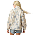 Woman wearing a patterned jacket with horse and rider design on a white background