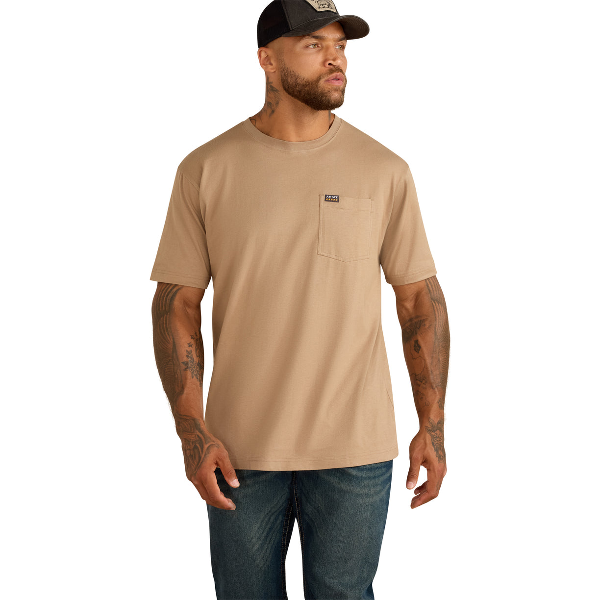 Tan pocket t-shirt paired with dark denim jeans and a cap