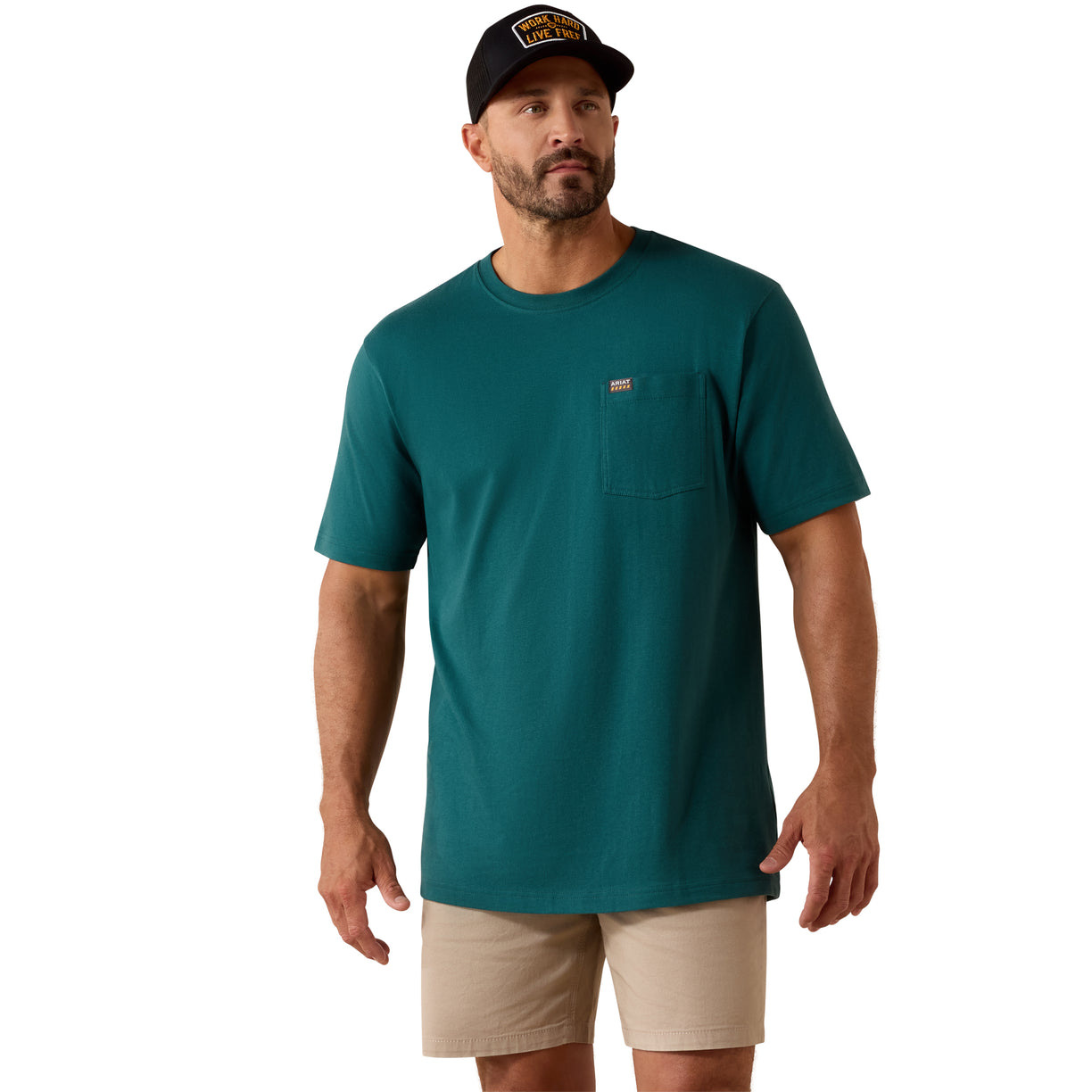 Teal pocket t-shirt worn with beige shorts and a cap