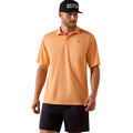 Man wearing the Ariat TEK Classic Fit Polo in peach-orange