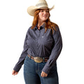 A woman modeling a dark navy long-sleeve western shirt with a white micro-dot pattern, paired with blue jeans, a brown leather belt with a large silver buckle, and a cream cowboy hat, against a solid white background.