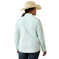 A woman shown from the back wearing a light mint green and white vertically striped long-sleeve button-down shirt, dark blue jeans, and a beige cowboy hat against a plain white background.