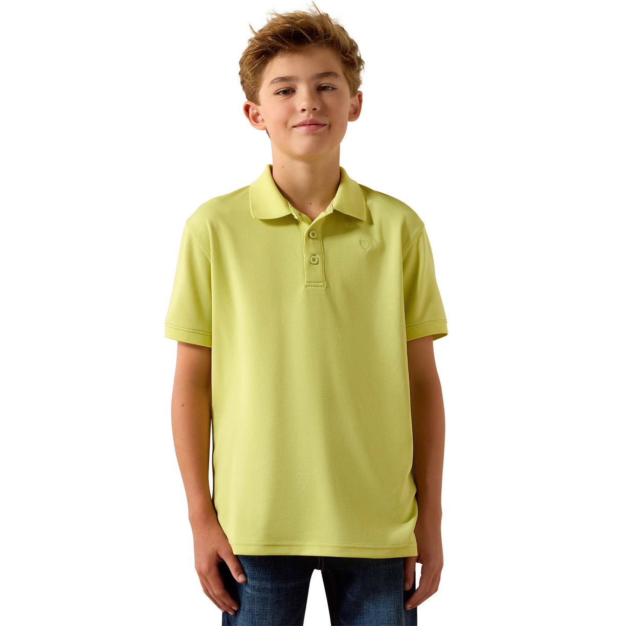 A young boy modelling a light yellow-green short-sleeve polo shirt with a two-button placket, paired with blue jeans
