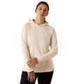 Woman wearing a beige hooded sun-protection top with long sleeves