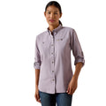 Woman wearing a lavender long sleeve work shirt with rolled up cuffs