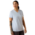 Woman wearing a pale blue V-neck T-shirt with a chest pocket