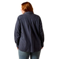 A woman with red hair is shown from the back wearing a dark navy blue textured button-down shirt and blue jeans against a plain white background.