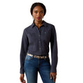 A woman modeling a dark slate blue long-sleeve western-style button-up shirt with a textured pattern, paired with blue jeans and a patterned belt, against a solid white background.