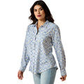 Woman wearing a blue patterned shirt on a white background