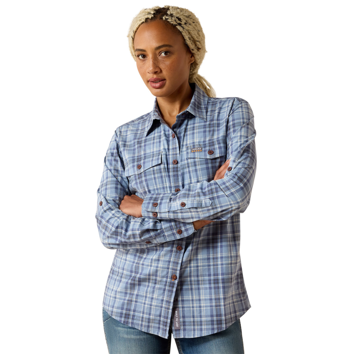 Woman wearing a blue and grey plaid long sleeve work shirt with double chest pockets