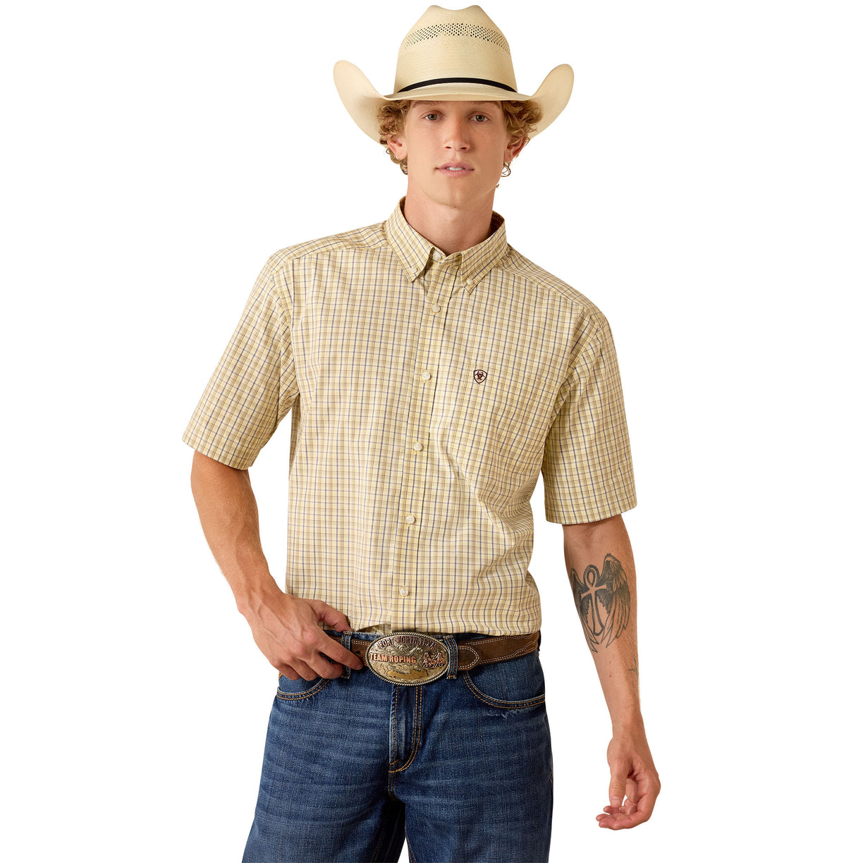 The Pro Series Preistly Classic Fit Shirt in a beige and yellow gingham check, short-sleeve, styled with a straw hat and jeans.