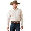 Cream button-down with a fine dot print and single chest pocket, tucked and paired with a leather belt.