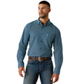 A man wearing a blue long-sleeve button-down shirt with a small white geometric pattern, paired with blue jeans and a brown belt, against a plain white background.