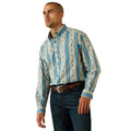 Man wearing a patterned shirt with blue accents on a white background