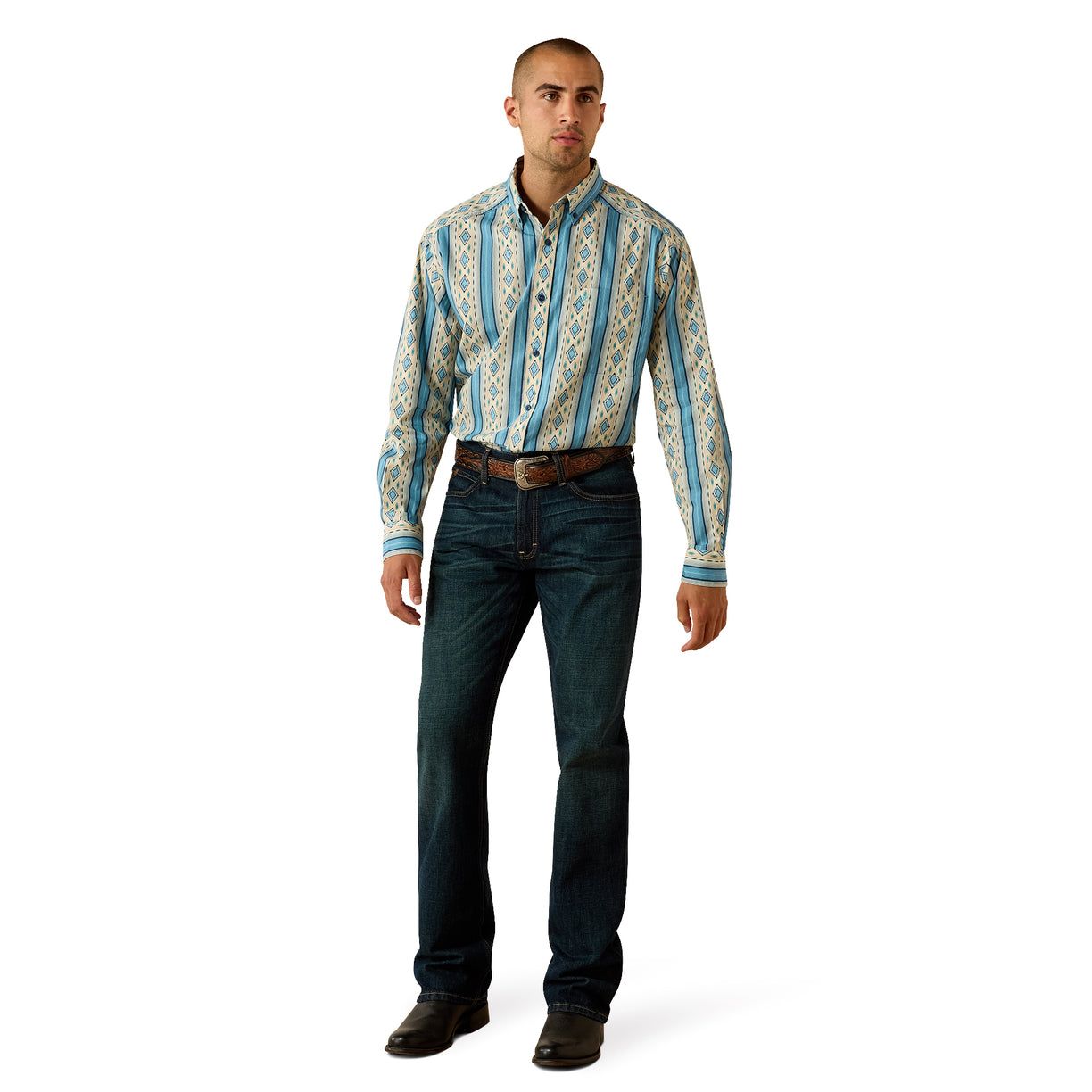 A man modeling a long-sleeve button-down shirt with vertical blue and beige geometric patterns, paired with dark blue jeans and brown shoes, on a white background.