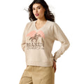 Woman wearing a beige sweatshirt with a graphic design on a white background