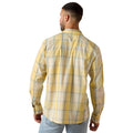 A man viewed from the back wearing a yellow and cream plaid long-sleeve button-down shirt with light blue jeans, set against a plain white background.