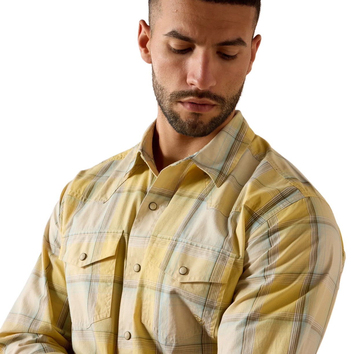 A man wearing a yellow and beige plaid button-down shirt, shown from the chest up against a plain white background.