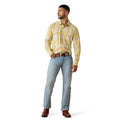 A man modeling a yellow and white plaid western-style button-down shirt, paired with light blue jeans, a brown belt, and brown boots, against a plain white background.