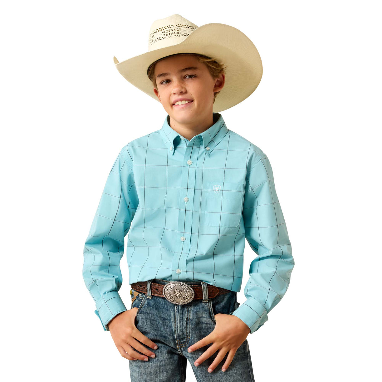 A young cowboy wearing a light blue plaid western shirt, jeans, and a cowboy hat