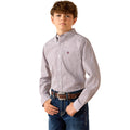A young boy modelling a long-sleeve Ariat button-down shirt with a small geometric pattern in light gray and white, paired with blue jeans and a brown belt