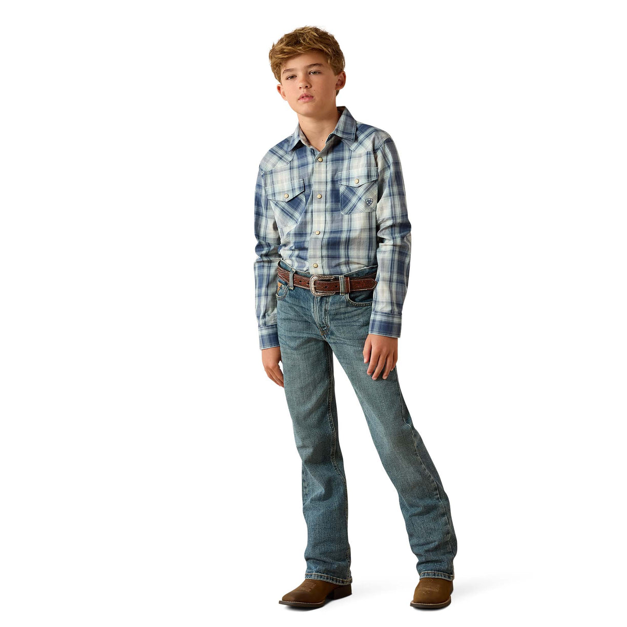 A young boy modeling a blue and white plaid western long-sleeve shirt with blue jeans, a brown belt, and brown boots, standing against a solid white background.
