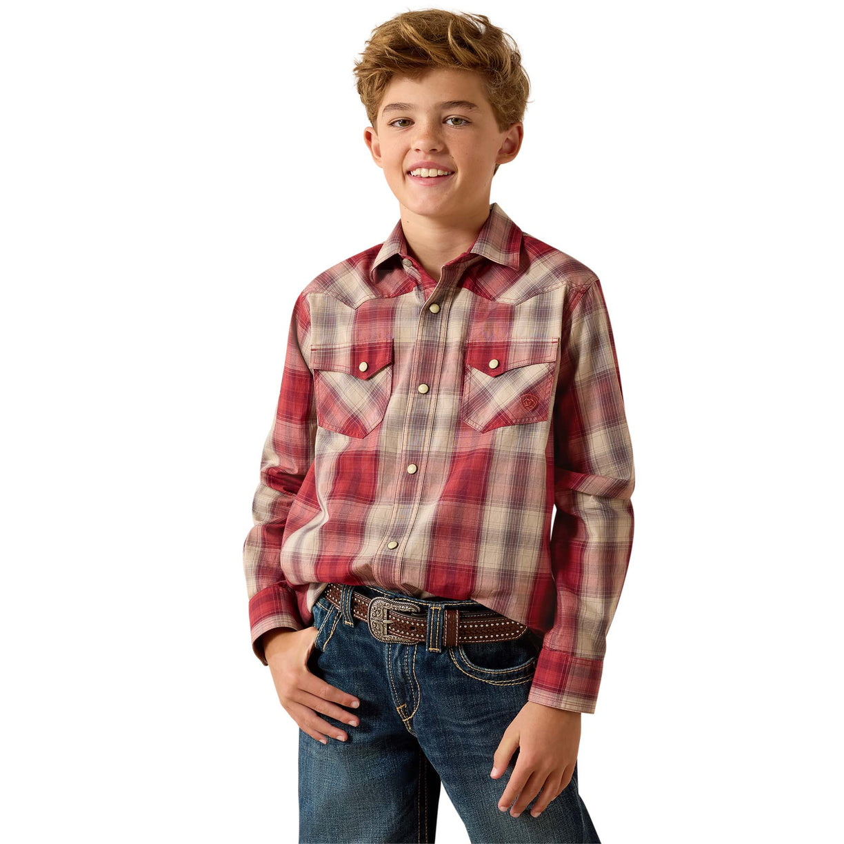 A young boy modeling a red and beige plaid western long-sleeve shirt with blue jeans, photographed against a solid white background.