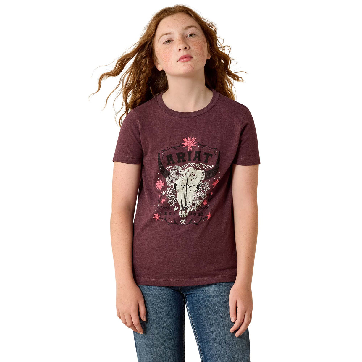 Girl wearing a maroon t-shirt with a graphic design on a white background
