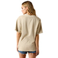 Woman wearing a beige t-shirt and denim shorts on a white background