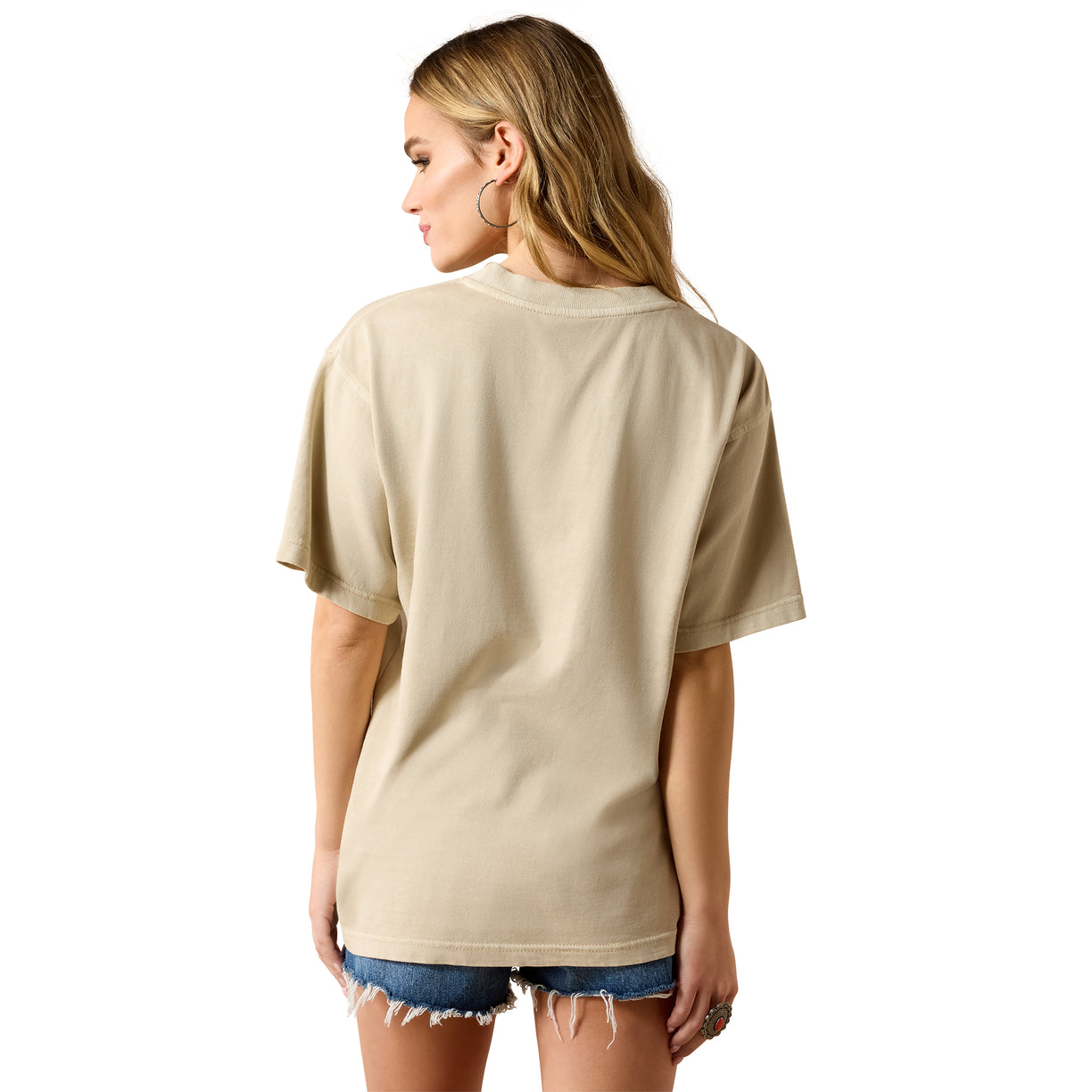 Woman wearing a beige t-shirt and denim shorts on a white background