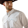Man wearing a patterned shirt and cowboy hat on a white background