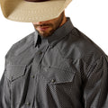 Man wearing a black and white checkered shirt with a beige cowboy hat on a white background