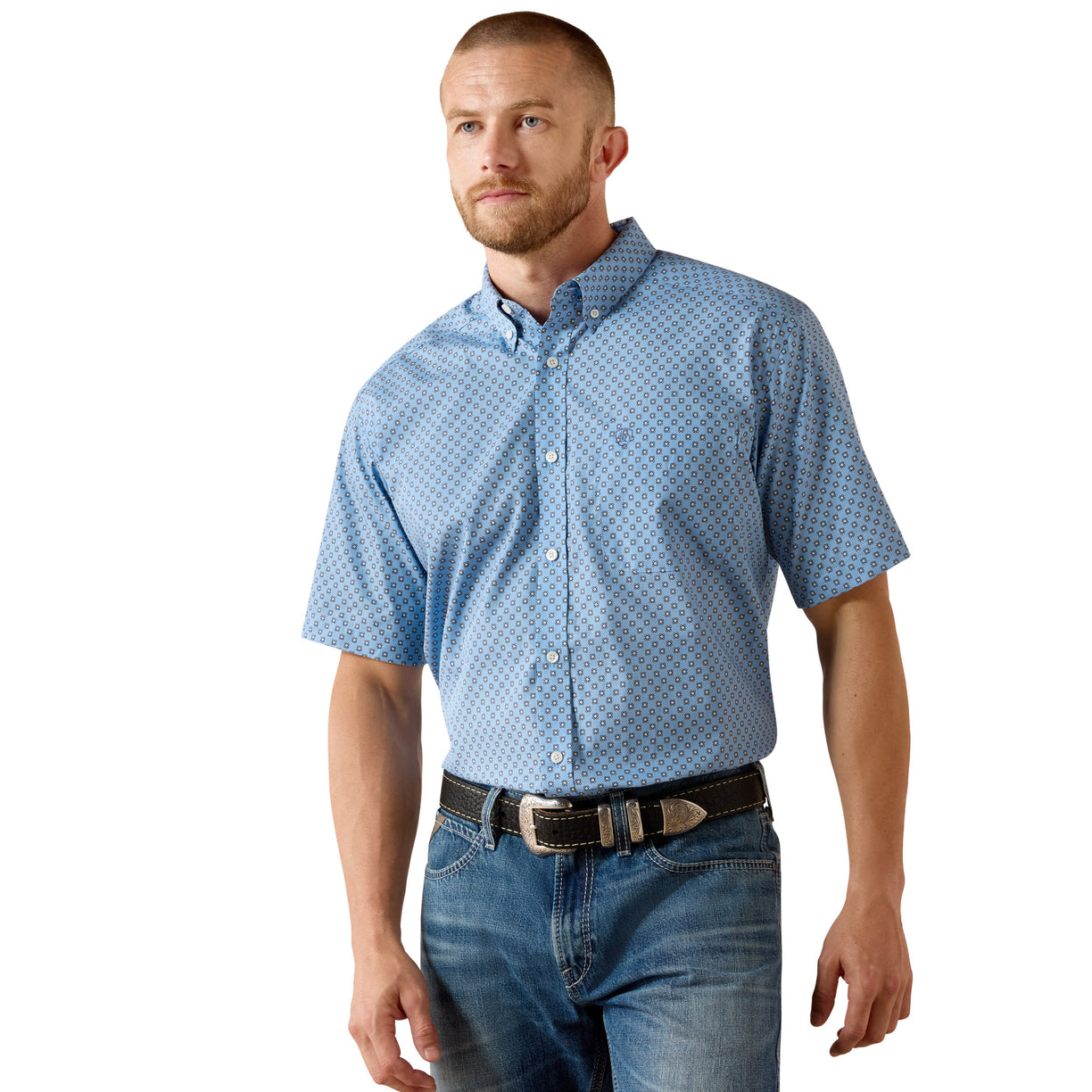 Blue medallion-print short-sleeve shirt tucked into denim with a leather belt.