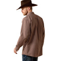 Man wearing a brown checkered shirt and cowboy hat against a beige background