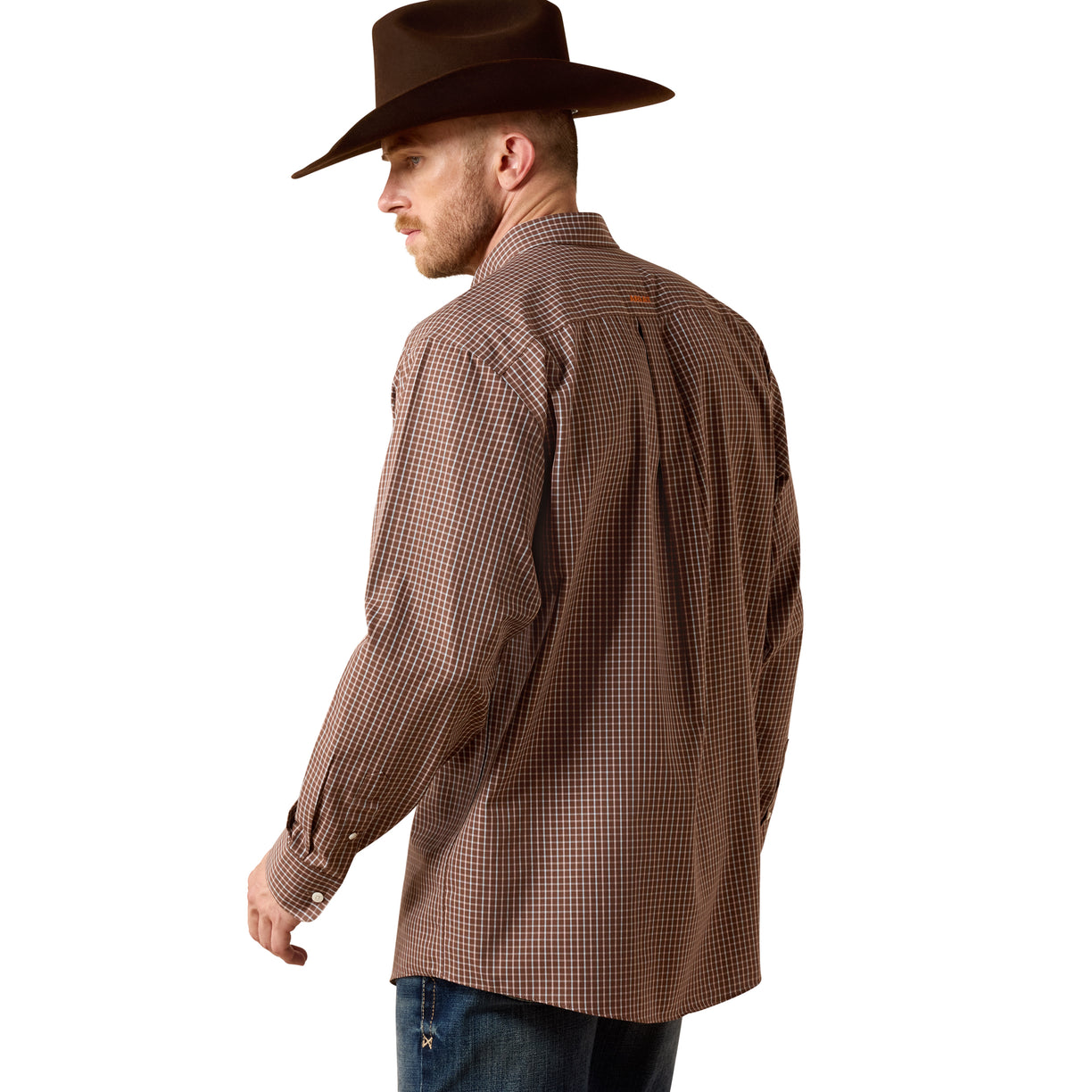 Man wearing a brown checkered shirt and cowboy hat against a beige background