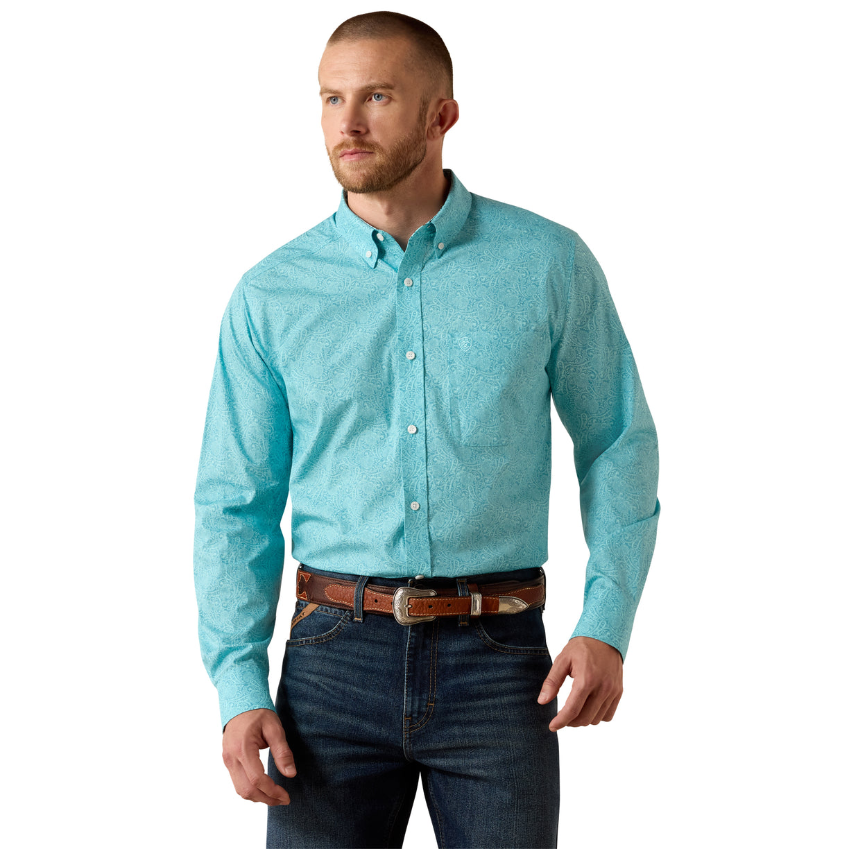 Man wearing a light blue button-up shirt and dark jeans on a white background
