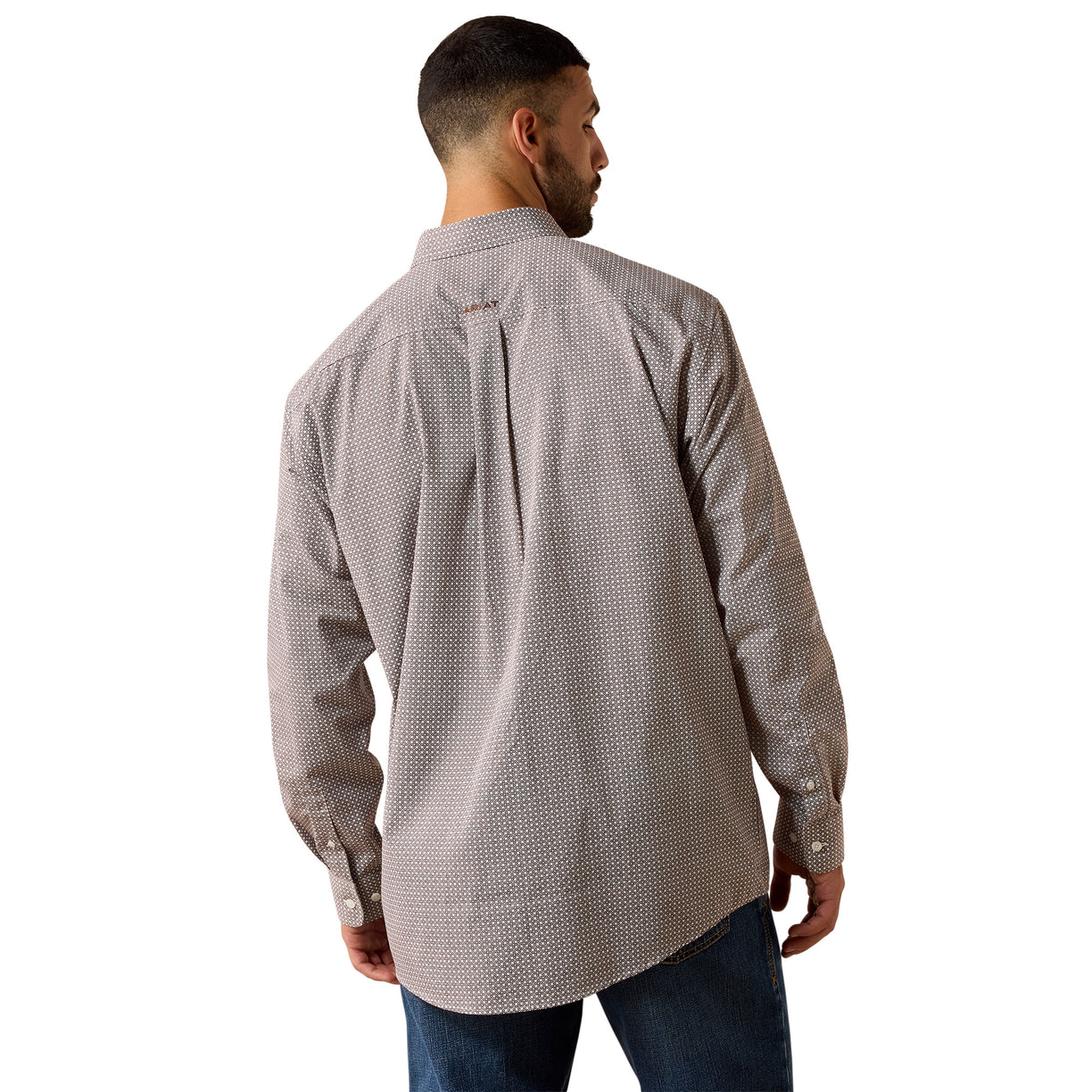 A man viewed from the back wearing a light gray and white micro-patterned button-down shirt and blue jeans against a plain white background.