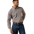 Man wearing a patterned shirt and jeans on a white background
