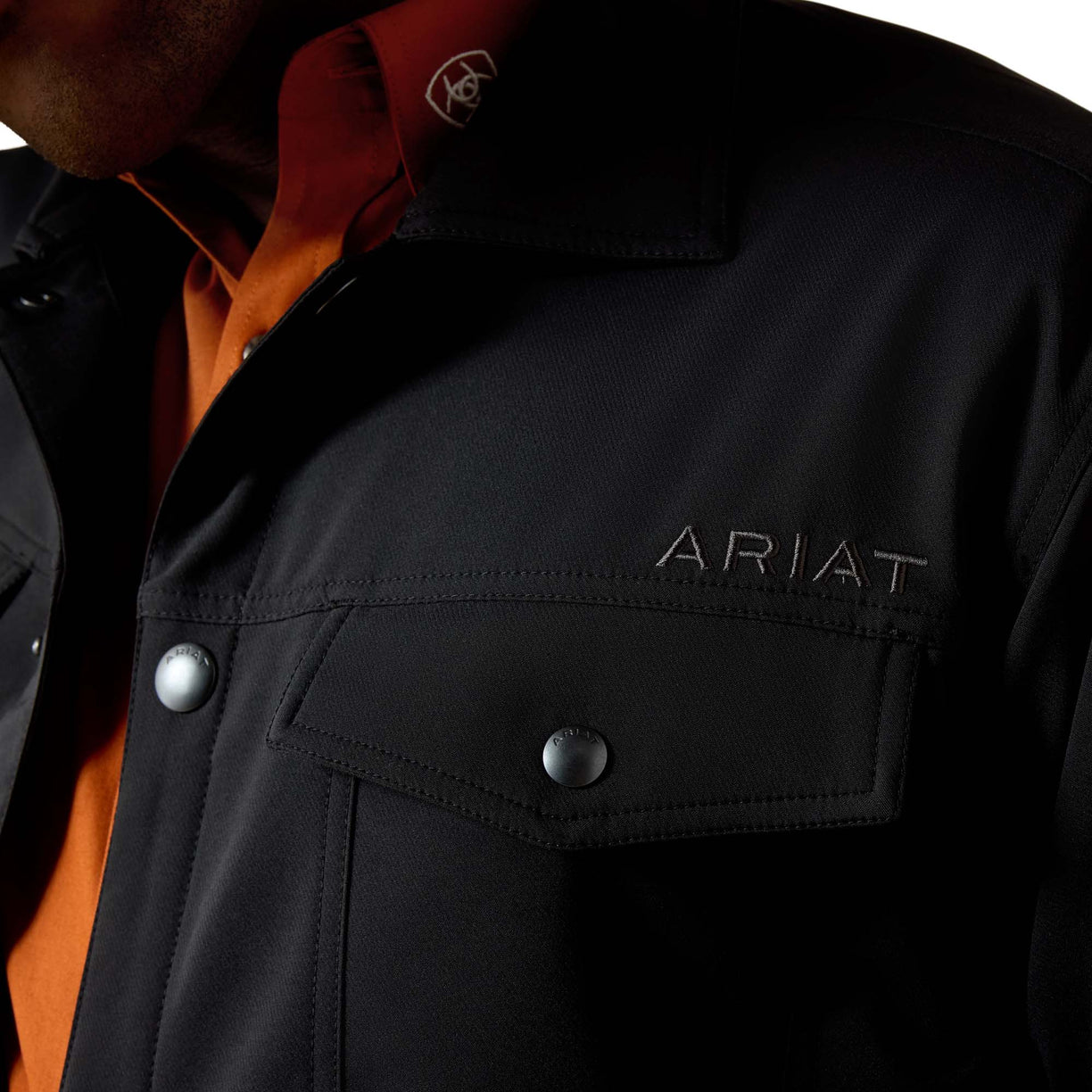 Black jacket with Ariat branding on a white background