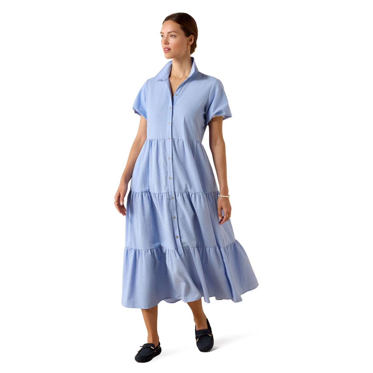 Woman wearing a light blue dress on a white background