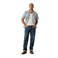 Man wearing a striped shirt, white t-shirt, blue jeans, and brown shoes on a white background