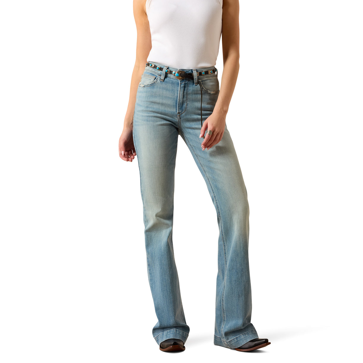 Person wearing light blue jeans on a white background