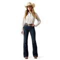 Woman wearing a white shirt, blue jeans, and a straw cowboy hat on a white background